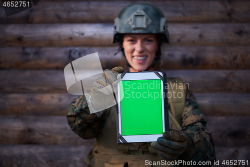 Image of woman soldier using tablet computer