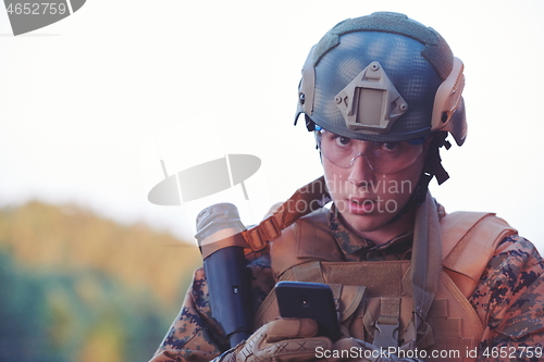 Image of soldier using smart phone