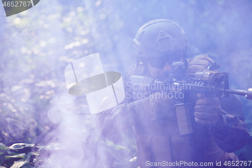 Image of soldier in action aiming  on laser sight optics