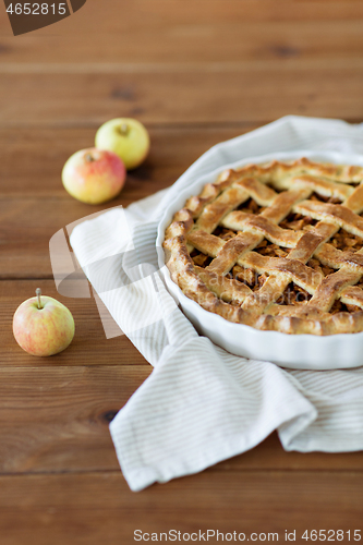 Image of close up of apple pie in baking mold on towel