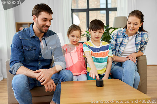 Image of happy family with smart speaker at home