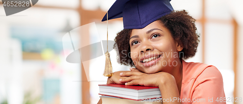 Image of african american graduate student with books