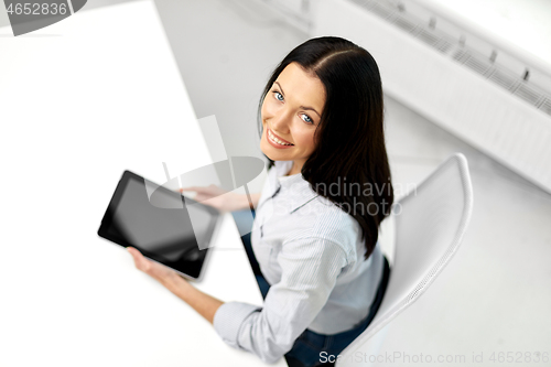 Image of businesswoman with tablet computer at office
