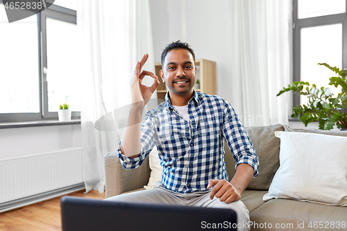Image of indian male blogger showing ok hand sign at home