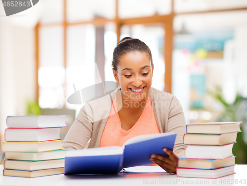 Image of african american female student reading book