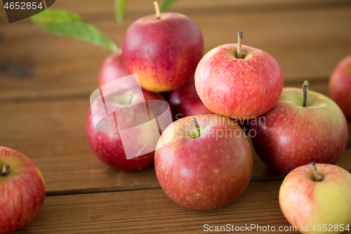 Image of ripe red apples on wooden table