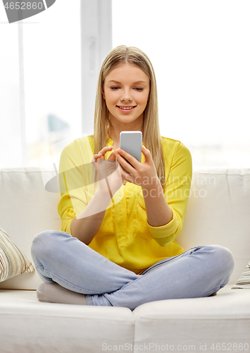 Image of young woman or teen girl with smartphone at home