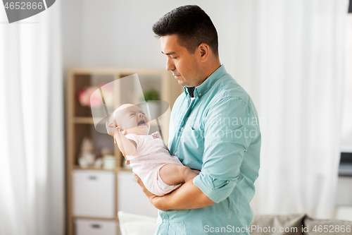 Image of middle aged father with baby daughter at home