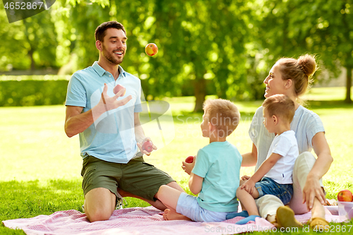 Image of happy family having picnic at summer park