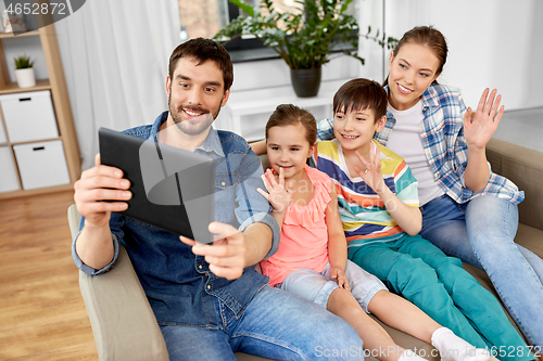 Image of happy family having video call on tablet computer