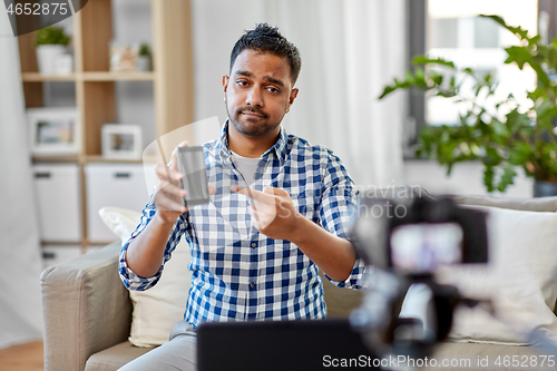 Image of male blogger with smartphone videoblogging