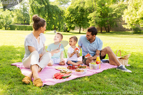 Image of happy family having picnic at summer park