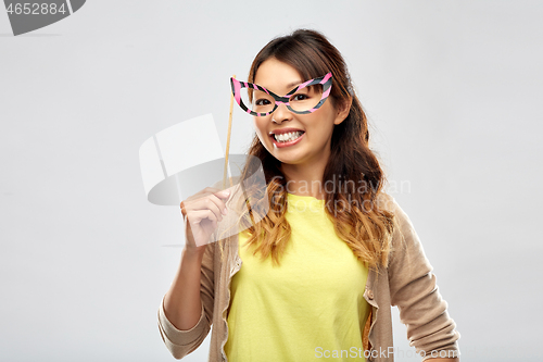 Image of happy asian woman with big party glasses