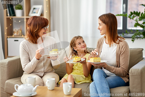 Image of mother, daughter and grandmother eating cake