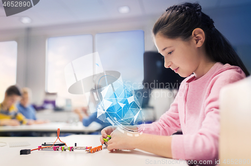 Image of girl building robot at robotics school