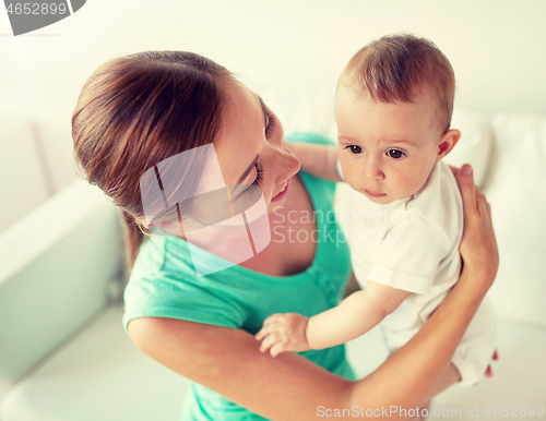 Image of happy young mother with little baby at home