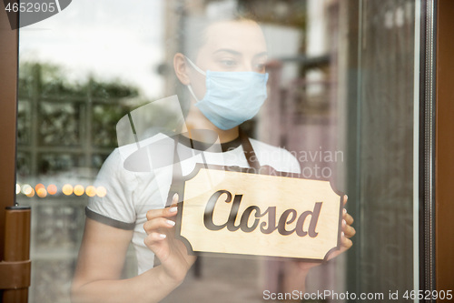 Image of Closed sign on the glass of street cafe or restaurant