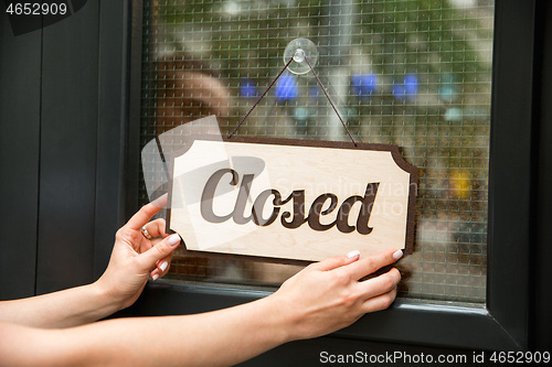 Image of Closed sign on the glass of street cafe or restaurant