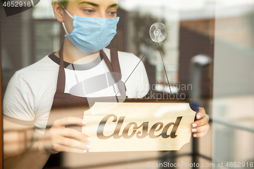 Image of Closed sign on the glass of street cafe or restaurant