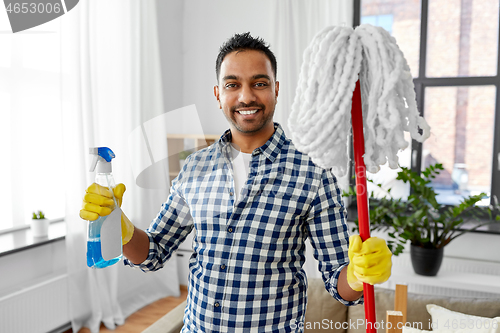 Image of indian man with mop and detergent cleaning at home