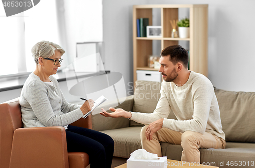 Image of senior woman psychologist and sad man patient