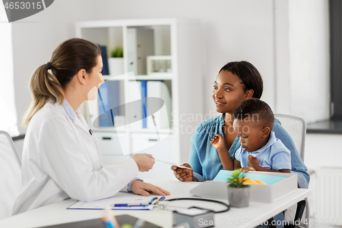 Image of happy mother with baby son and doctor at clinic