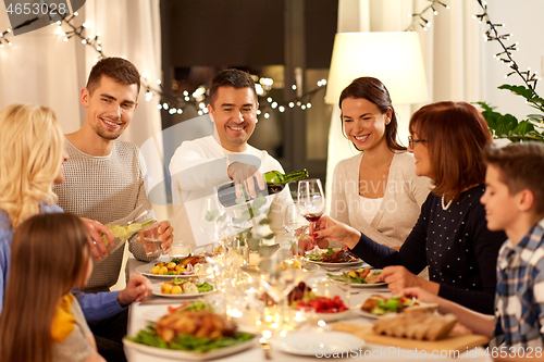 Image of happy family having dinner party at home