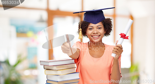 Image of african graduate student with books and diploma