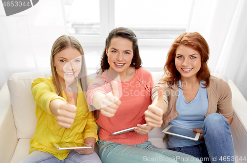 Image of teenage girls with tablet pc showing thumbs up