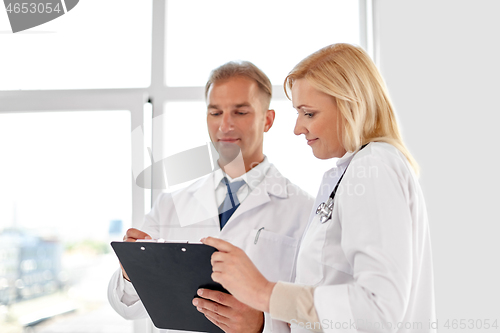 Image of smiling doctors with clipboard at hospital