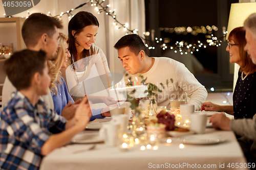 Image of happy family having birthday party at home