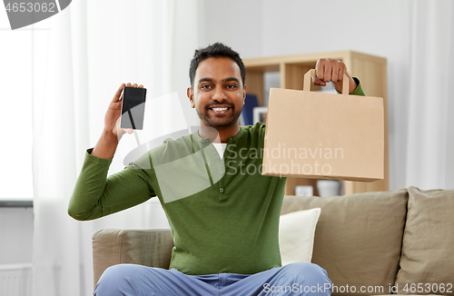 Image of indian man using smartphone for food delivery