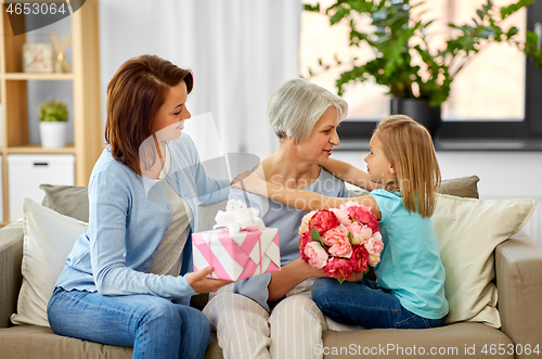 Image of granddaughter hugging and greeting grandmother