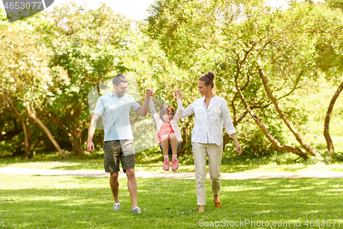 Image of happy family walking in summer park