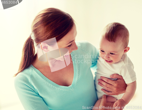 Image of happy young mother with little baby at home