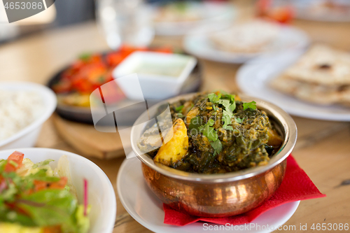 Image of close up of aloo palak dish in bowl on table