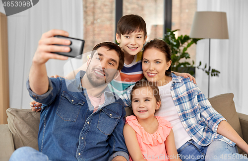 Image of happy family taking selfie at home