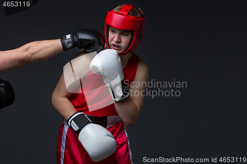 Image of young boxer is being punched