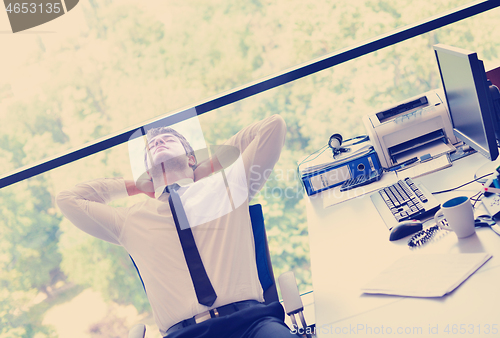 Image of happy young business man at office