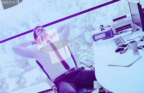 Image of happy young business man at office