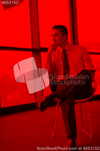 Image of happy young business man at office