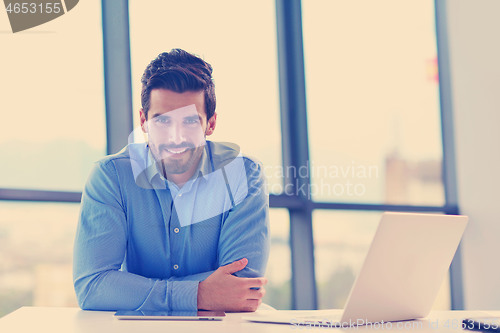 Image of happy young business man at office