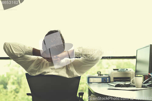 Image of happy young business man at office