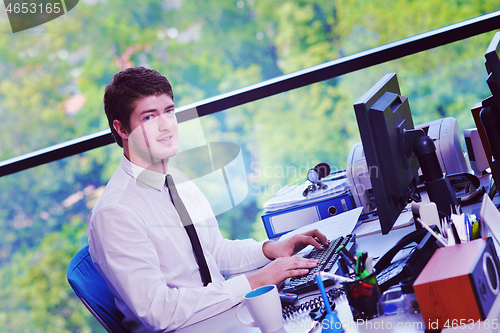 Image of happy young business man at office