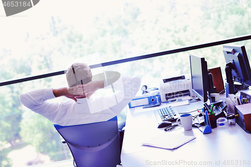 Image of happy young business man at office