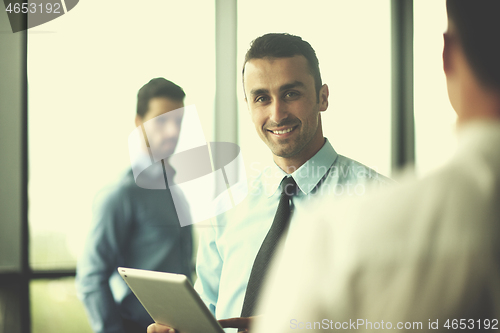 Image of business man using tablet compuer at office