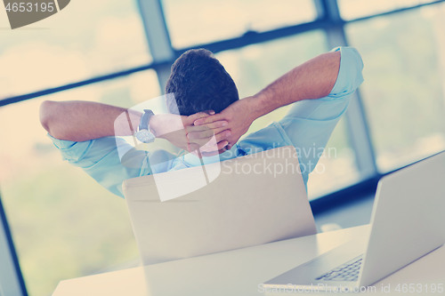 Image of happy young business man at office