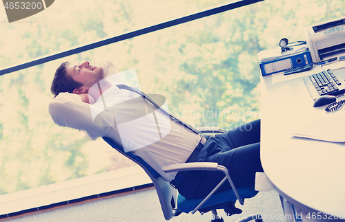 Image of happy young business man at office