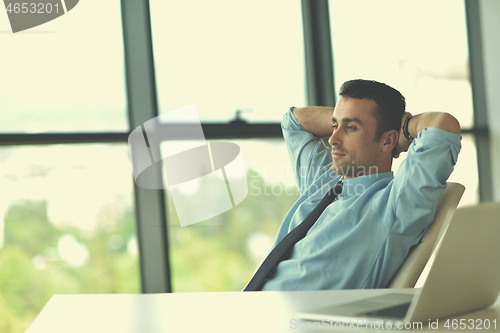 Image of happy young business man at office