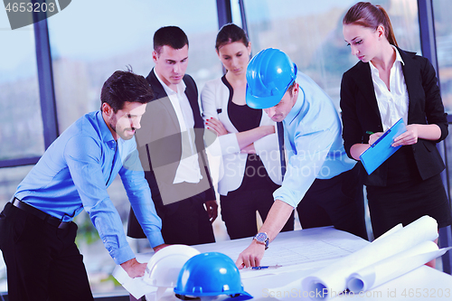 Image of business people and construction engineers on meeting